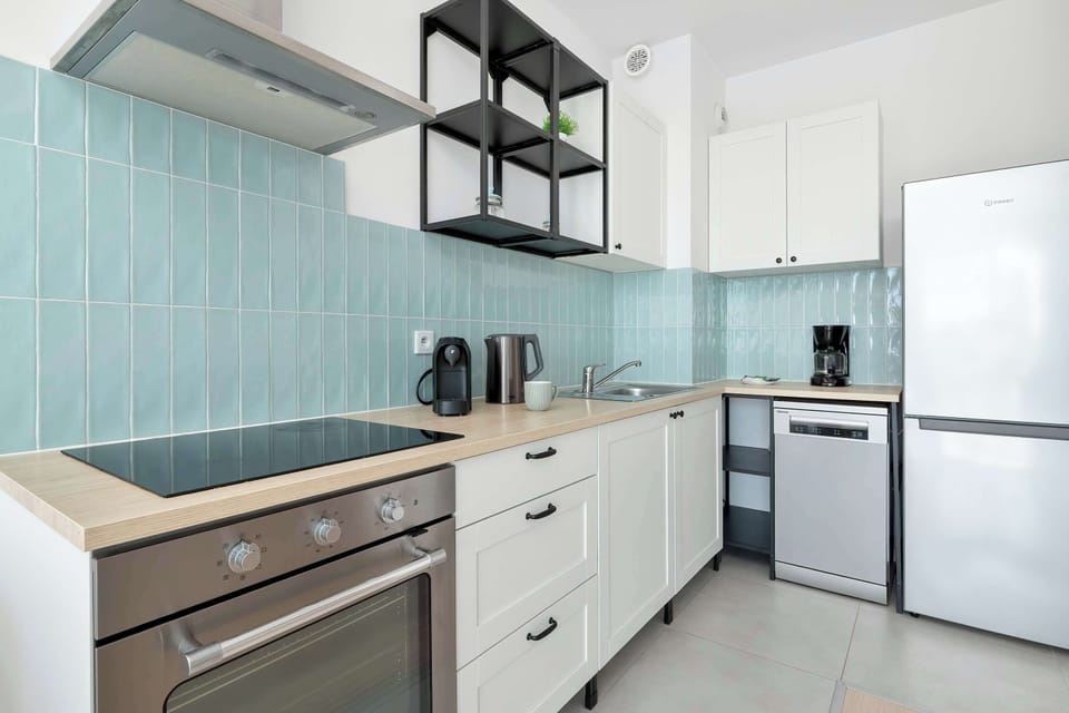 Modern kitchenette equipped with essential appliances, ample workspace, and everything needed to prepare meals with ease.