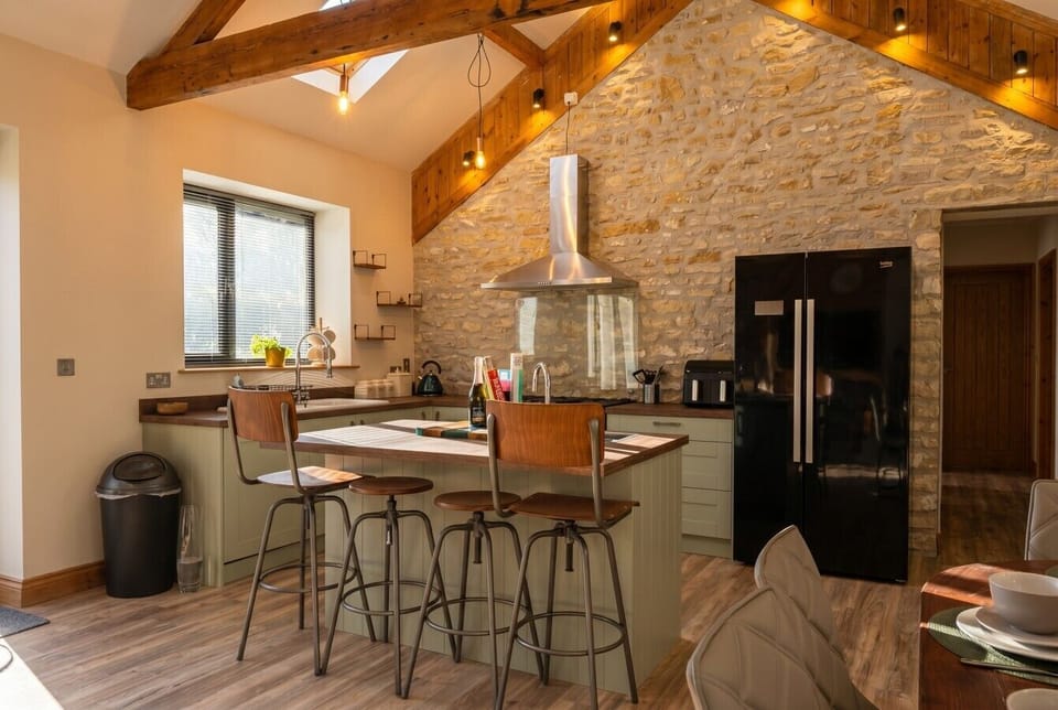Breakfast bar seating under the soaring beamed ceiling, perfect for morning coffee.