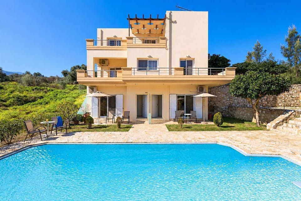 Stylish accommodation with access to a spacious shared pool, sun loungers, and relaxing outdoor areas.