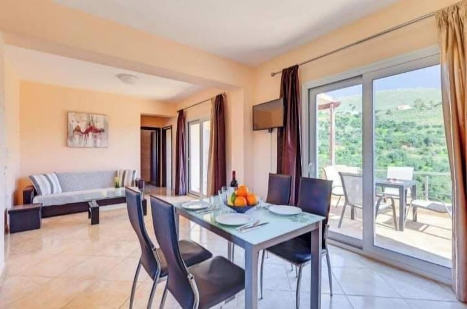 A comfortable and welcoming living space with a fully equipped kitchen, dining area, and direct access to the balcony.