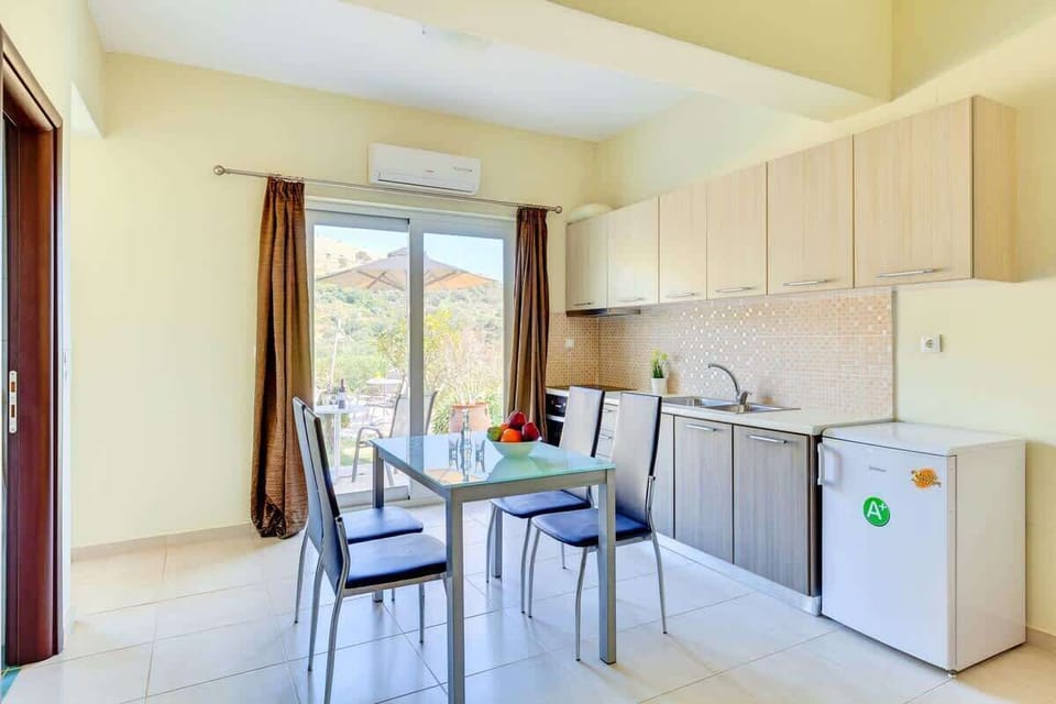Sun-filled private kitchen with direct access to the balcony, offering a bright and welcoming atmosphere.