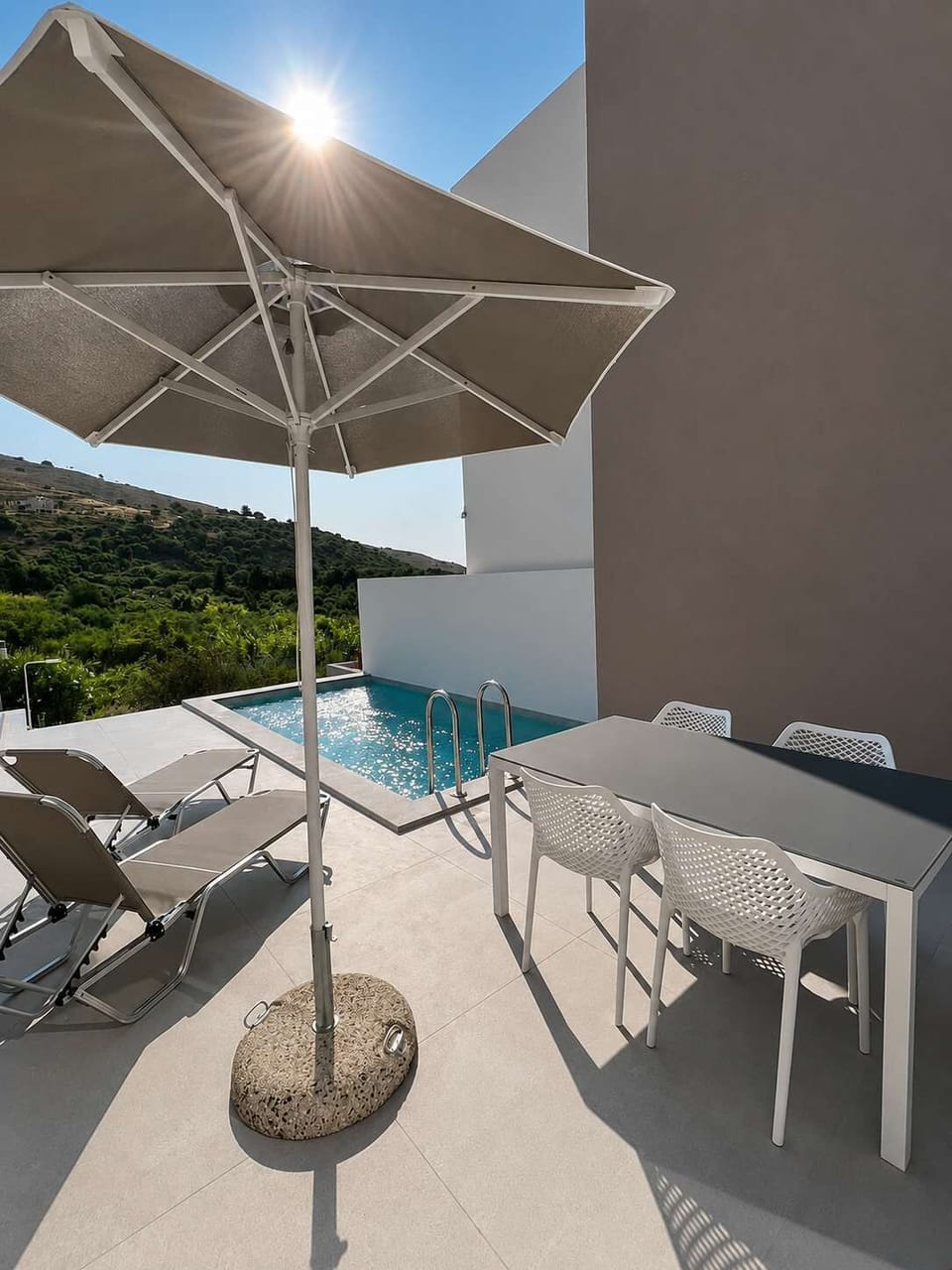 Relax on your private terrace with a refreshing plunge pool, sun loungers, and outdoor dining area—perfect for enjoying Crete’s sunshine and peaceful hillside surroundings.