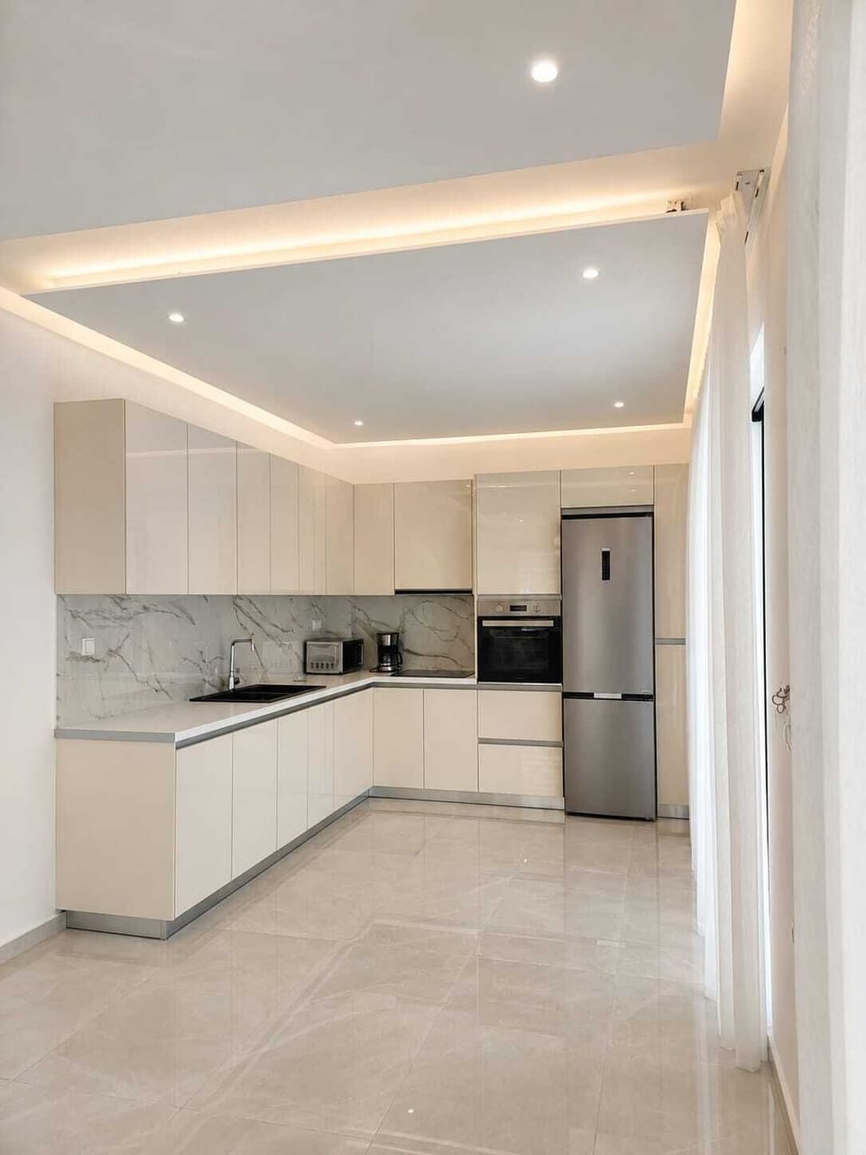 Fully equipped kitchen featuring premium appliances and sleek contemporary design.