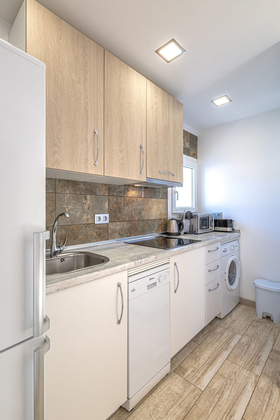 Plenty of counter space and modern amenities, including a washing machine for longer stays in Marbella.
