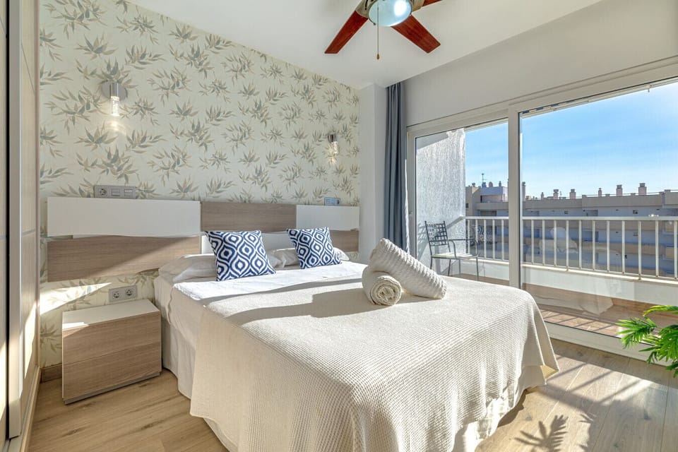 Wake up to stunning views of the Marbella coastline. This bright, airy bedroom features direct terrace access.
