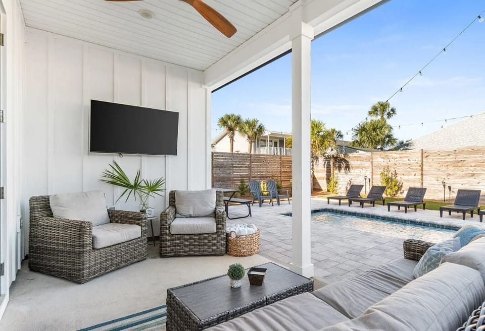 Unwind in your covered patio with plush seating, a flatscreen TV, and direct pool access—your private retreat for relaxation and entertaining.