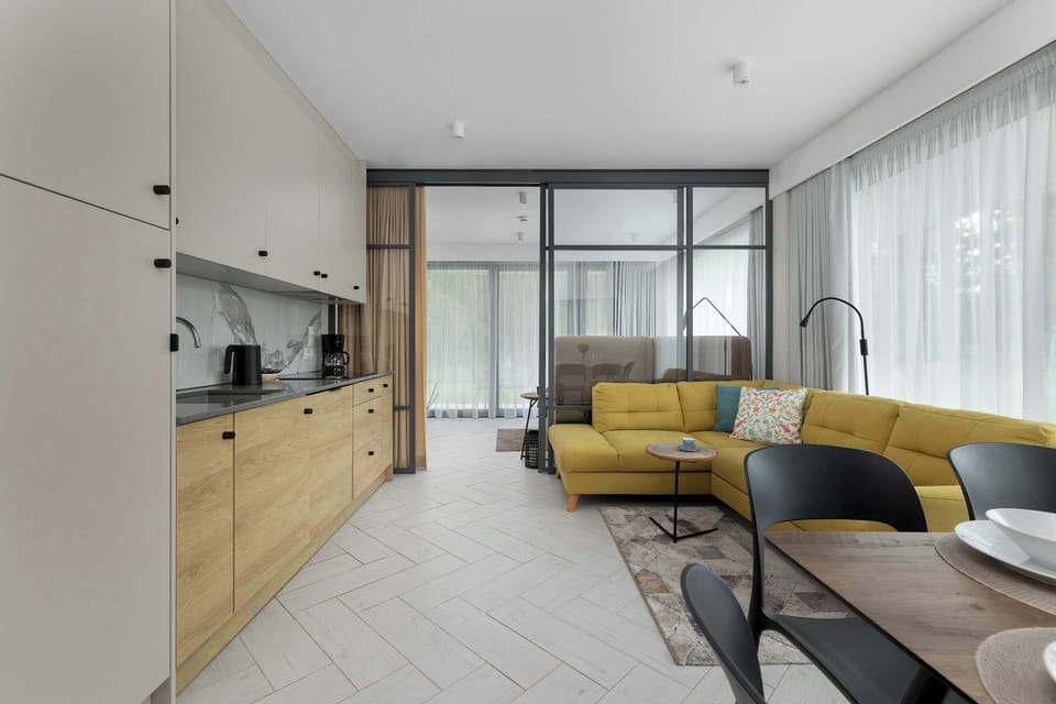 The living area features a sleek coffee table and a flat-screen television.