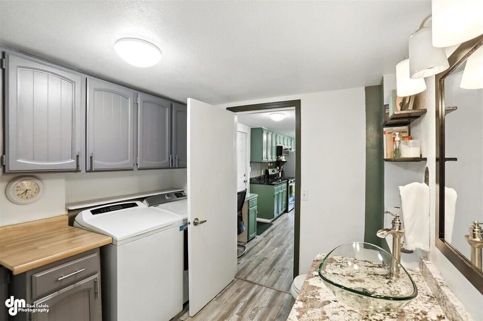 Laundry room and half-bath just off kitchen feature lots of storage and extra counter space