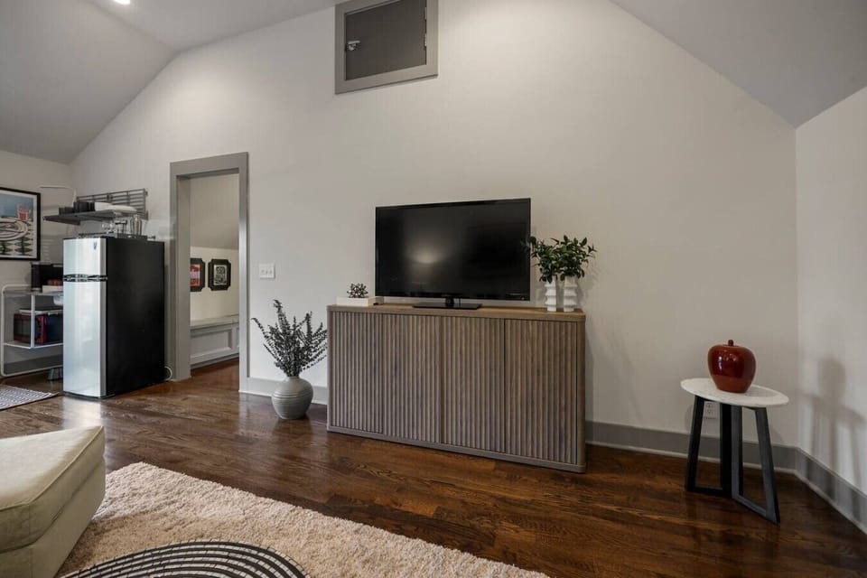 Bright lounge featuring a soft area rug and an open, airy flow.