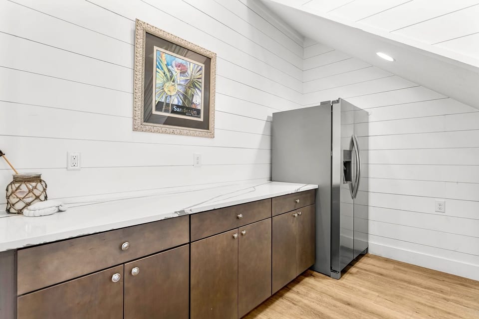 1st Floor- wet bar with full-size fridge and generous counter space—perfect for snacks and drinks without heading upstairs.