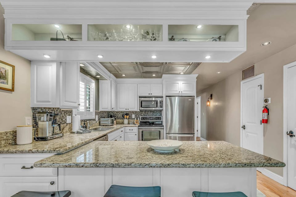 Kitchen: Drip coffee maker, tableware, cooking utensils
