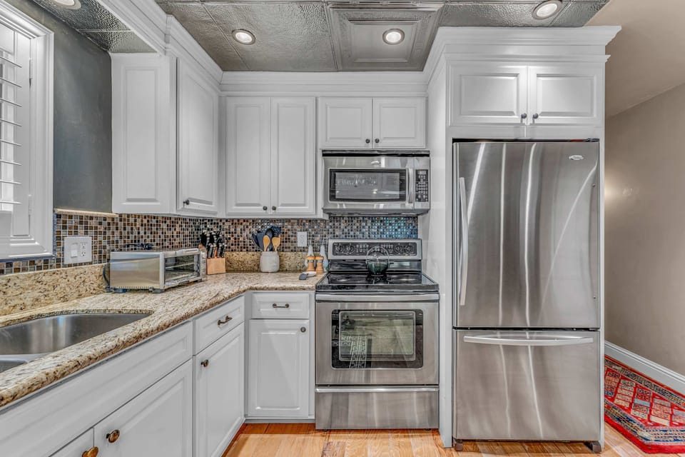 Kitchen: Drip coffee maker, tableware, cooking utensils
