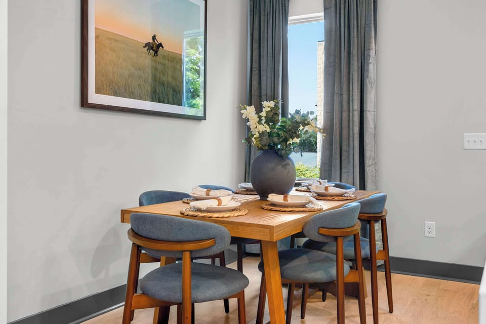 Another look at the dining table showing the full seating arrangement with 6 chairs. A natural gathering spot for the whole group.
