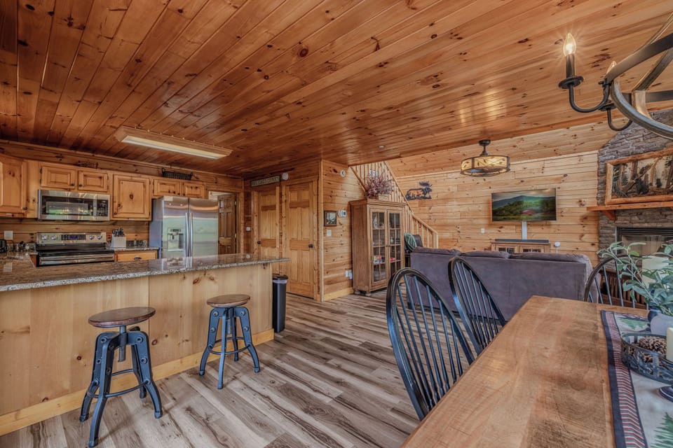 Spacious open-concept living area connecting the kitchen, dining space, and cozy seating areas for gathering together.