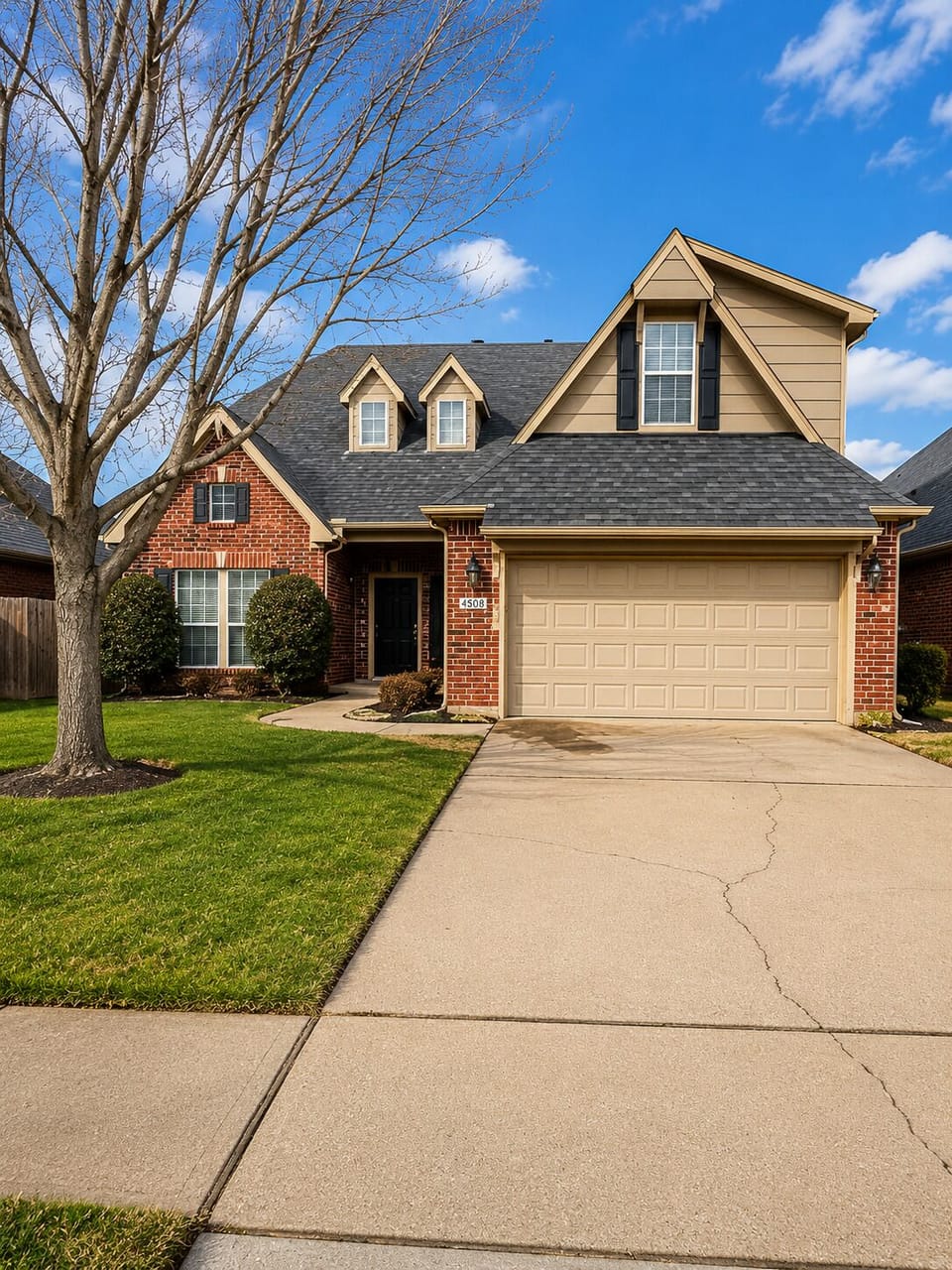 Spacious driveway and attached garage in a quiet neighborhood.