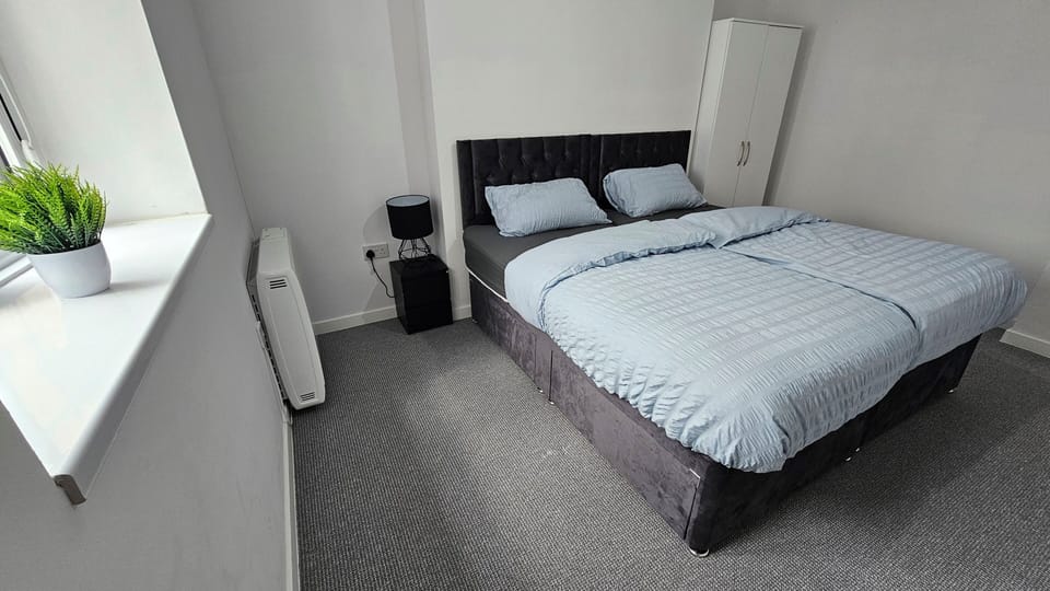 Bright, minimalist bedroom with comfy double bed and natural light