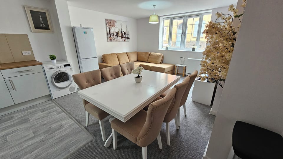 Bright open-plan lounge and dining space with comfy seating