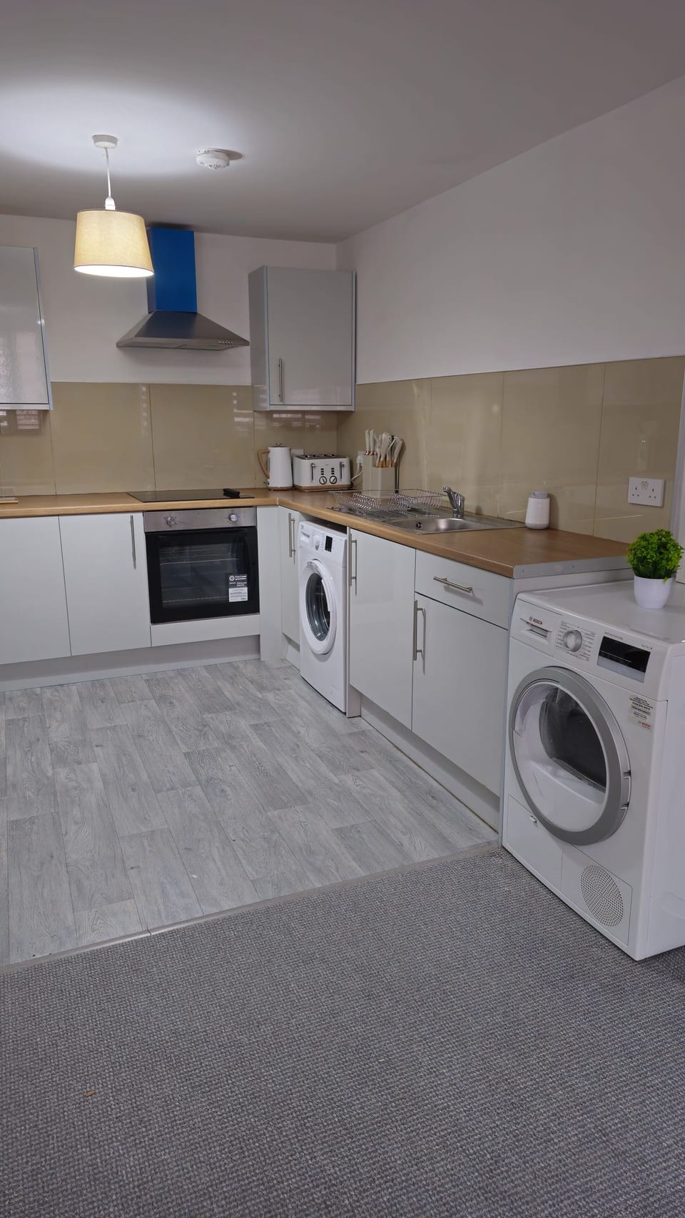 Bright modern kitchen with washer, dryer, and all the essentials