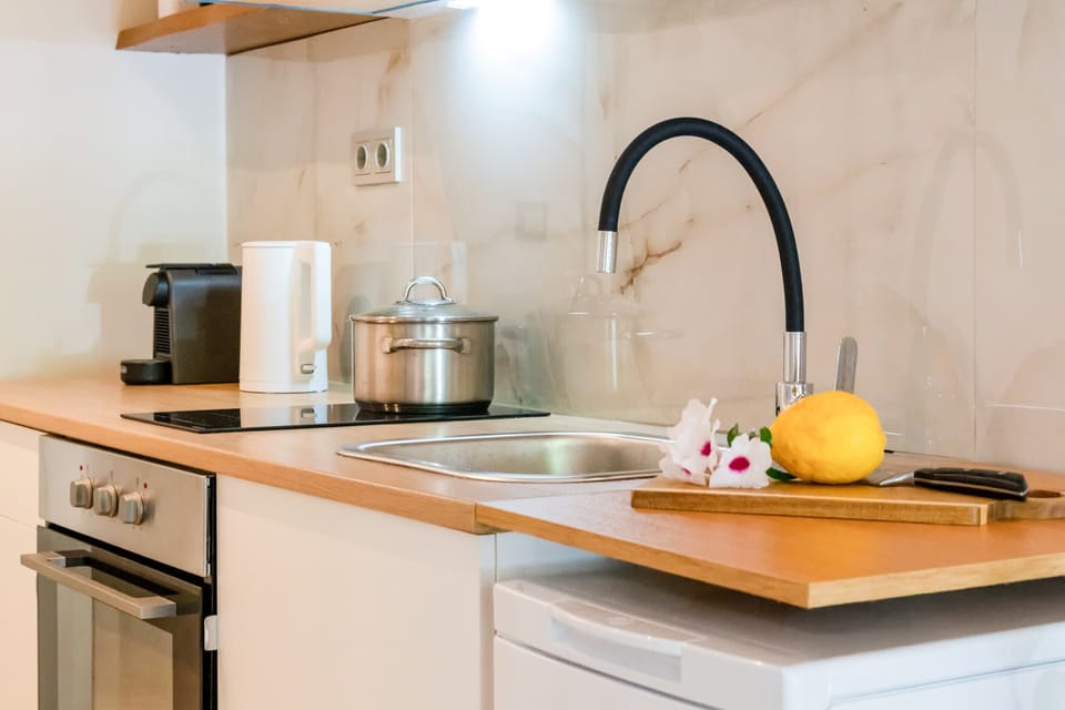 Thoughtful kitchen details including coffee maker, kettle, and cooking essentials.