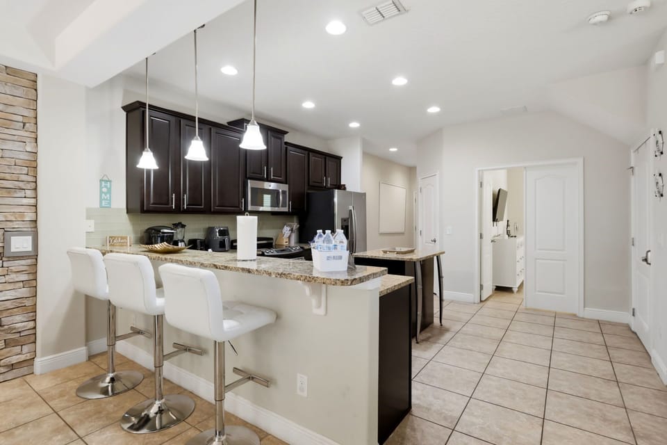Granite countertops, stainless appliances, and plenty of space for snacks, meals, and morning coffee.