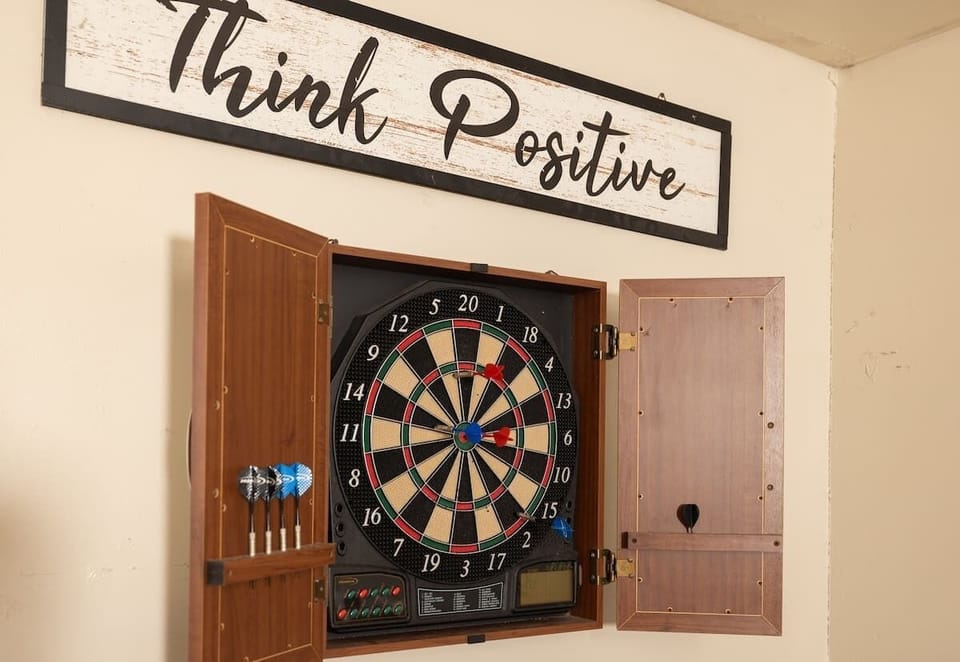 Dartboard mounted and ready—challenge your aim, celebrate bulls-eyes, and embrace the positive vibes. Perfect for unwinding with a friendly match.