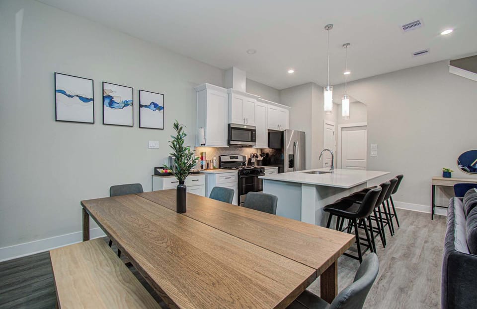 Gather, dine, and connect in this stylish open-concept space featuring a spacious dining table and chef-inspired kitchen.