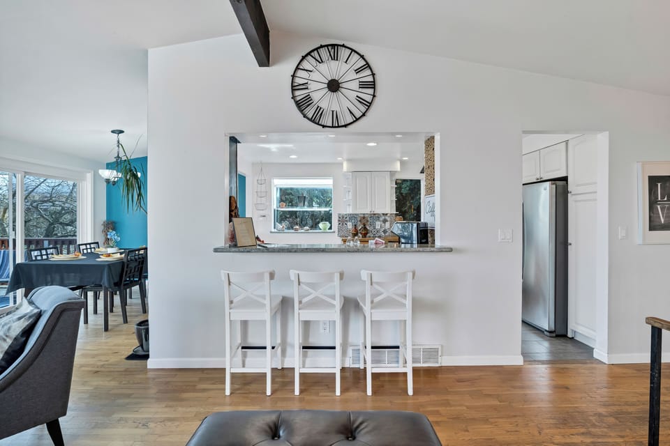 Bright open-concept living space with breakfast bar and sunny dining area