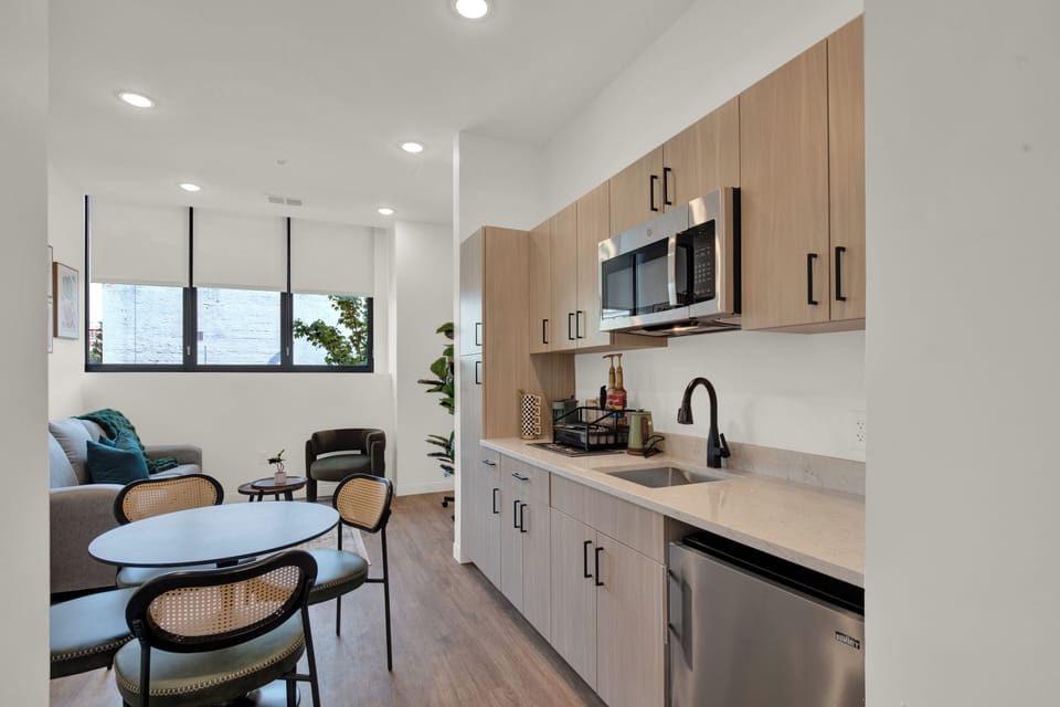 Bright modern kitchenette with dining nook and cozy lounge area