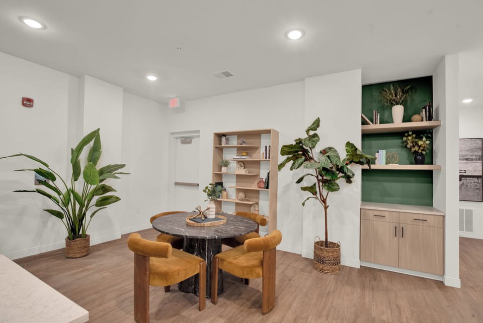 Bright modern dining nook with designer touches and built-in shelving
