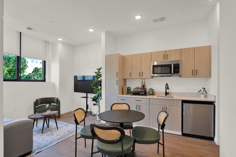Bright modern studio with kitchenette, dining for four, and cozy lounge area