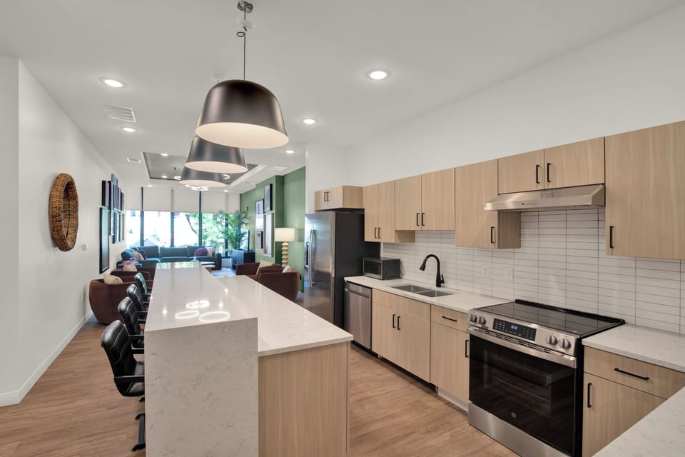 Bright modern kitchen with waterfall island and open-concept layout