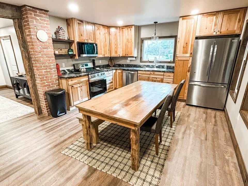 Gather ‘round the rustic dining table for home-cooked meals, game nights, or morning coffee in this warm and welcoming kitchen.