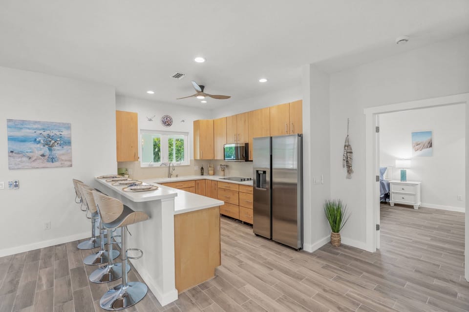 Prepare home cooked meals in the kitchen, bar stool seating at the counter for four.