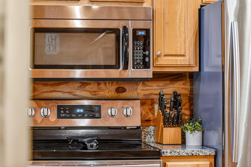 Fully stocked kitchen with stainless steel appliances and 4 person dining table