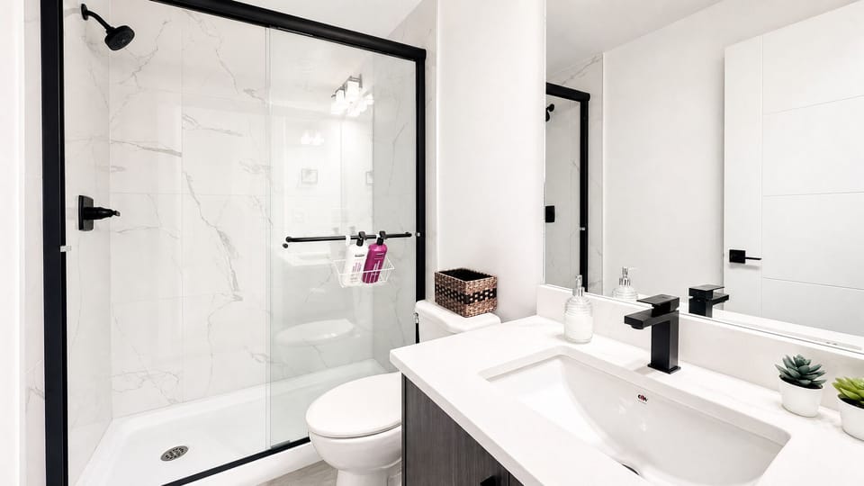 Bright modern bathroom with glass walk-in shower and sleek finishes