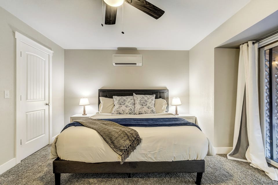 Bedroom THREE also on the main level offers a KING bed and Smart TV, ensuite bathroom and access to the backyard