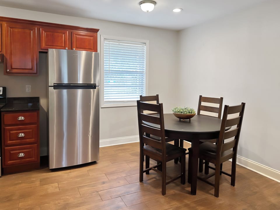 Bright dining nook with seating for four beside the modern kitchen