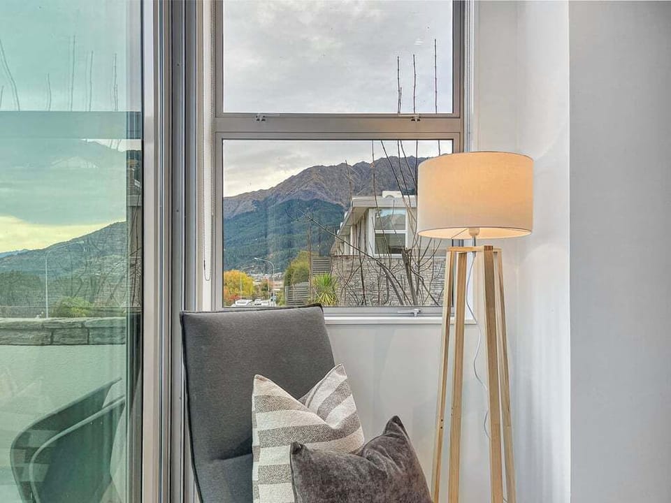 Large window showcasing Queenstown's natural beauty.