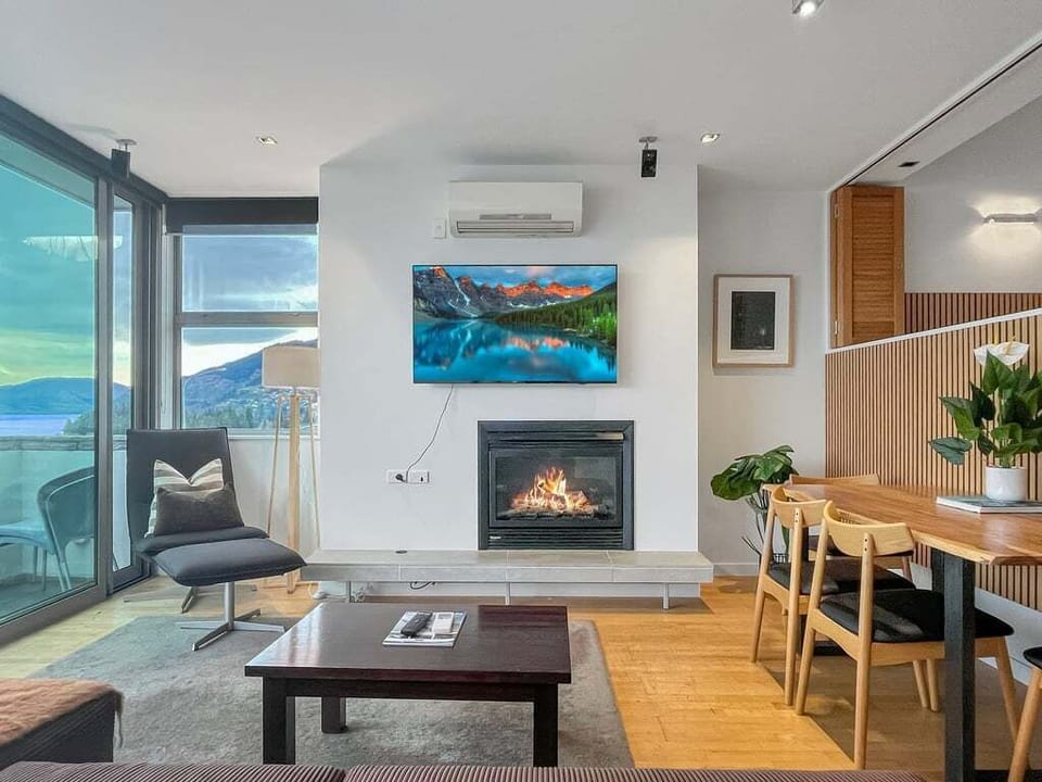 Bright living space with warm timber accents and lake views.