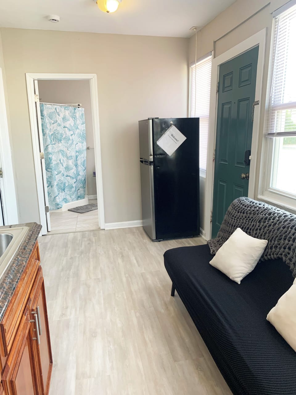 Bright studio nook with futon, natural light, and private bath access