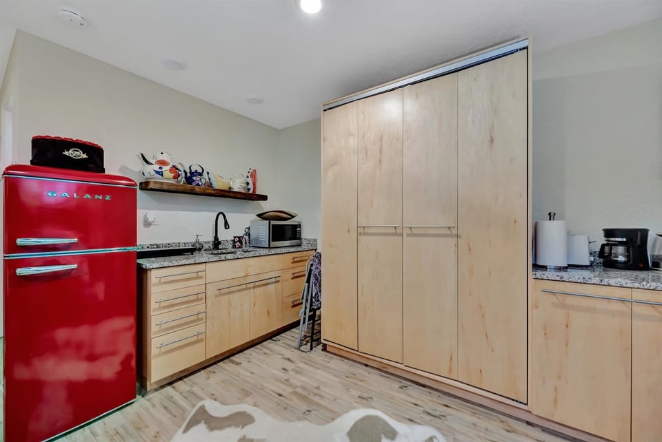 Retro red refrigerator, induction stove, sink, and microwave