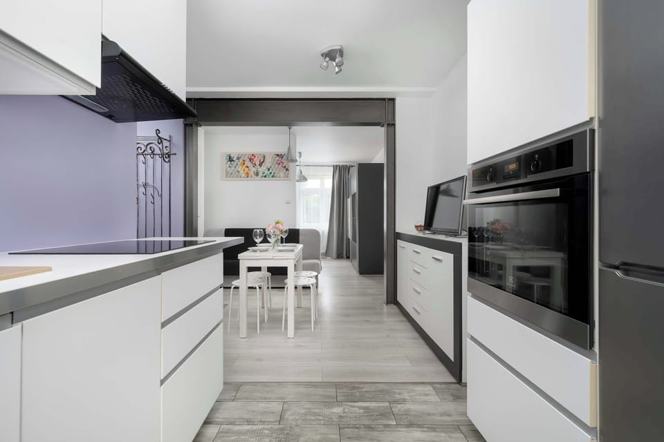 The sleek design of the kitchenette blending seamlessly with the living area.