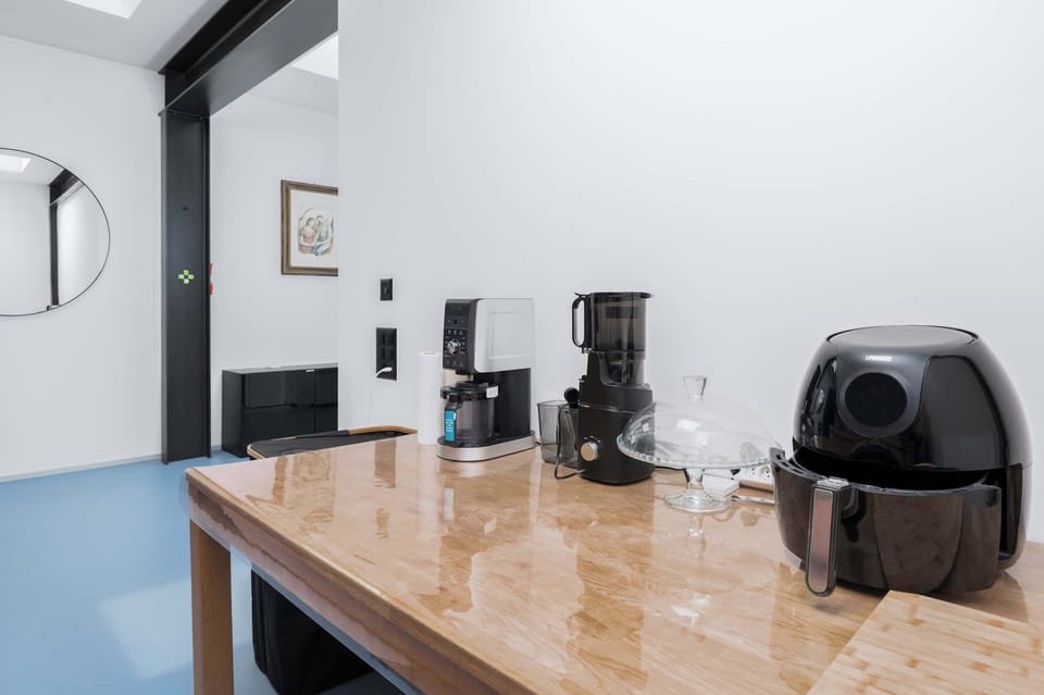 Coffee station with coffee machine and kitchen essentials.
