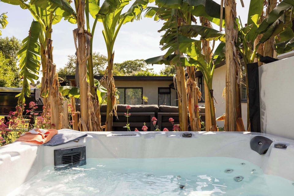 A peaceful hot tub spot framed by tropical-style planting