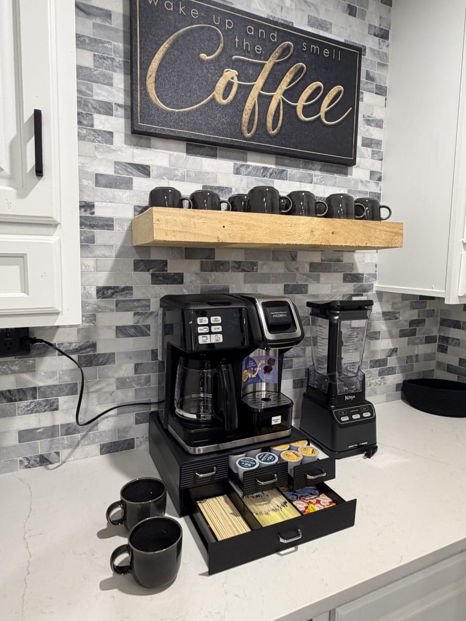 Inviting coffee bar with drip maker, blender, mugs, and pod selection