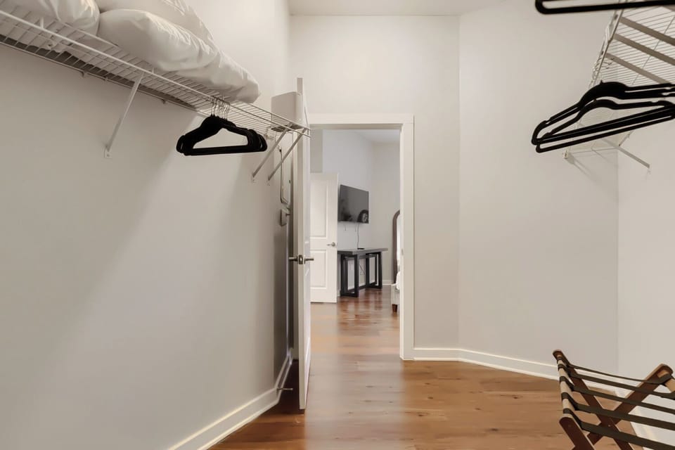 large walk-in closet with hangers and luggage racks