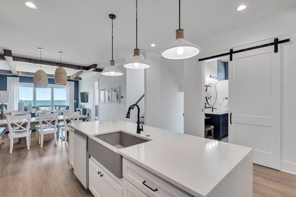 Picture yourself preparing meals at this stylish kitchen island, where coastal light fills the open space and those dreamy ocean views are just steps away, inviting you to unwind in your beachside retreat.