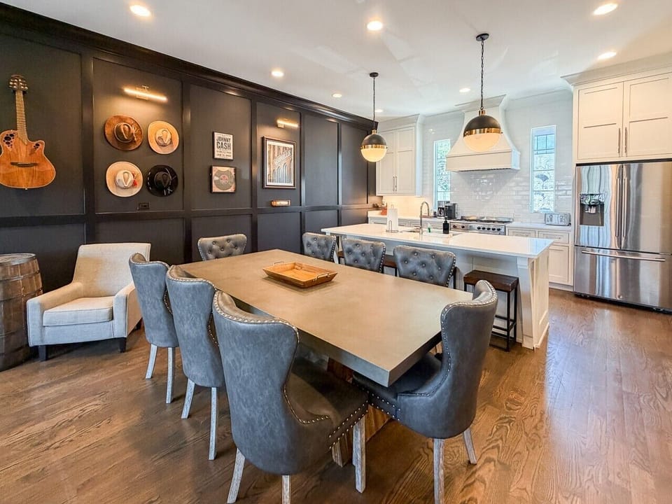 Eight person dining table in addition to four stools at the eat in kitchen, plenty of space to enjoy meals together