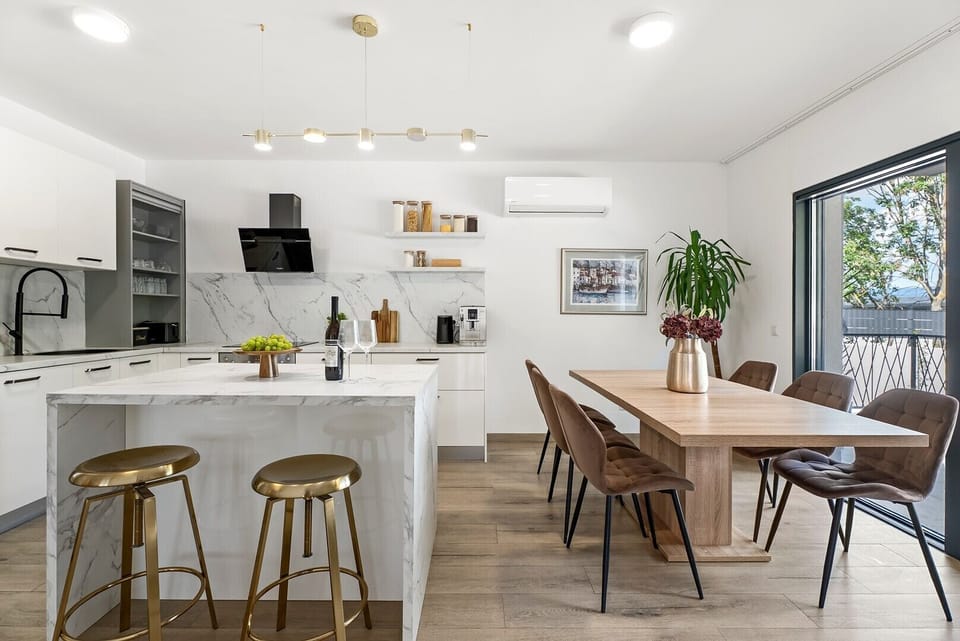 The modern kitchen is thoughtfully designed with high-quality appliances and ample storage space.