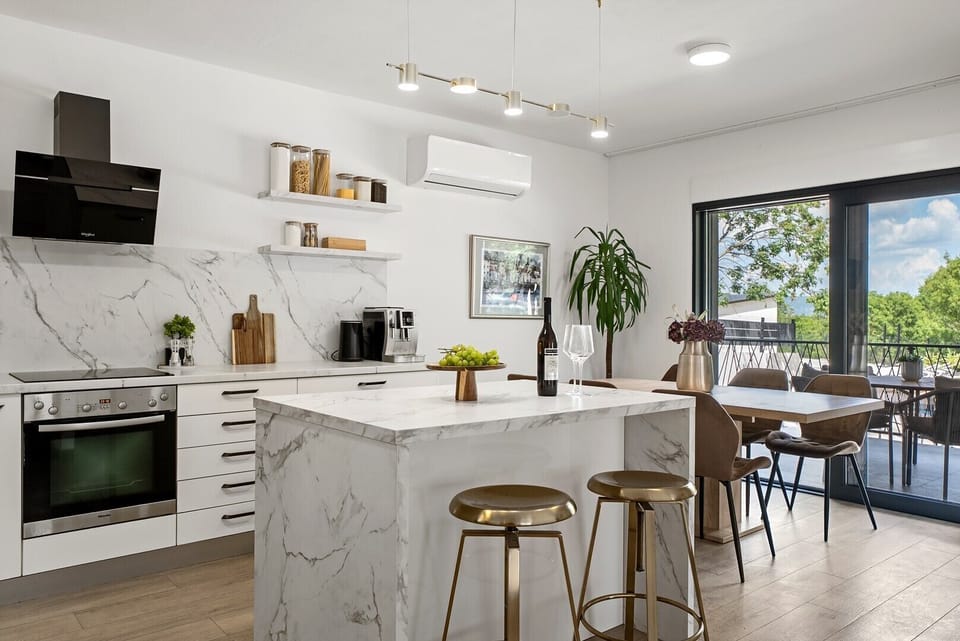 A fully equipped kitchen with a stylish kitchen island, high-quality appliances, and generous workspace, offering everything needed to create memorable culinary experiences.